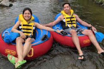 a group of people sitting on a raft in a body of water