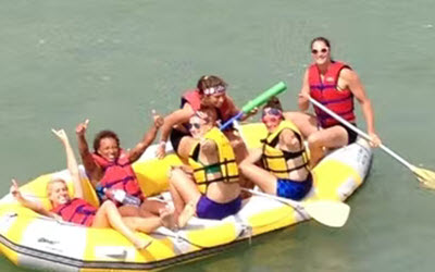 Young Group People Enjoying River Rafting