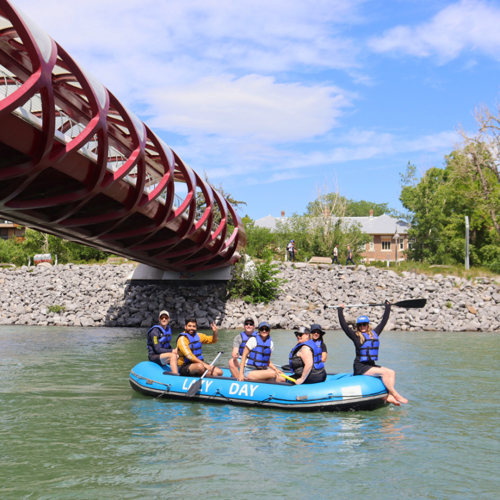 a group of people riding on the back of a boat in the water